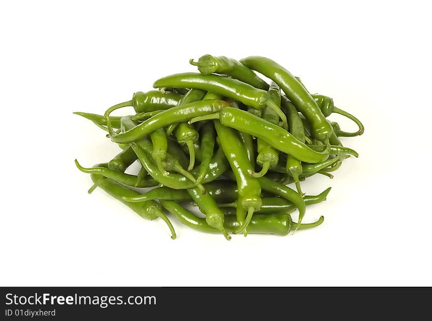 Dry green hot peppers at white. Dry green hot peppers at white