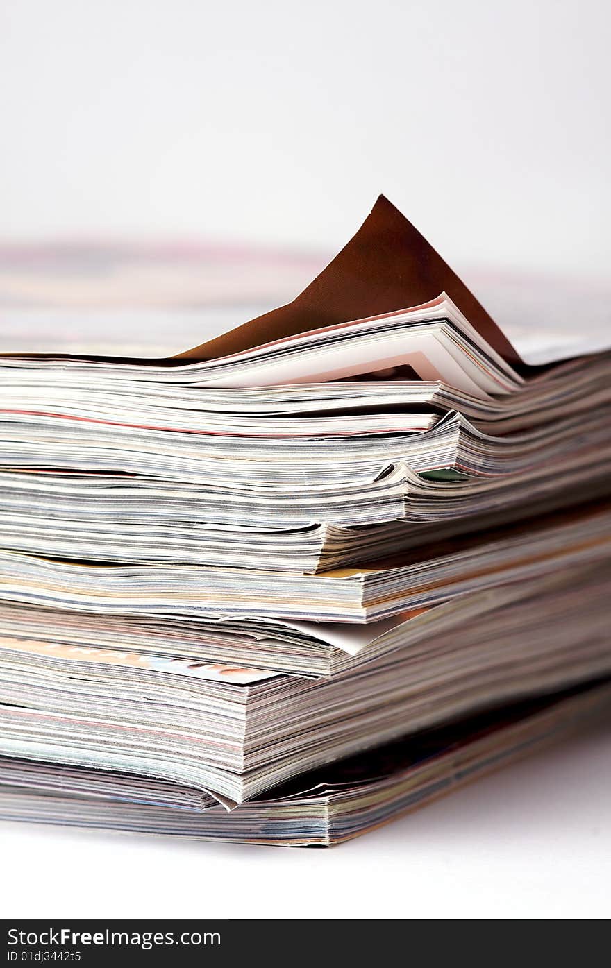 A stack of magazines on an isolated white background