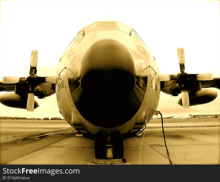 C 130 airplane Belgian army on tarmac, (front view) in sepia color. C 130 airplane Belgian army on tarmac, (front view) in sepia color.