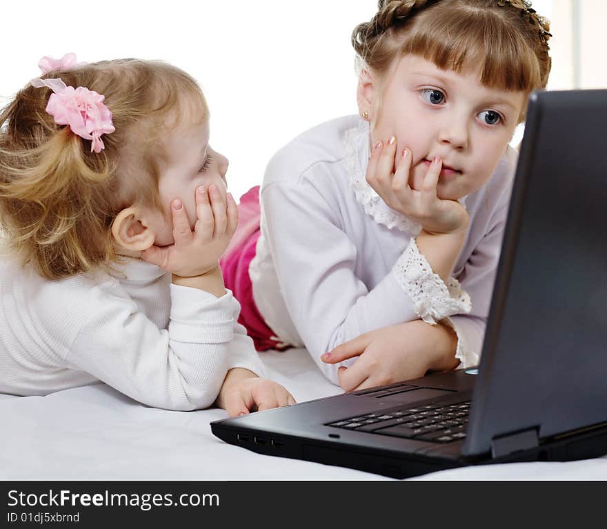 Stock photo: an image of two girls with a laptop. Stock photo: an image of two girls with a laptop