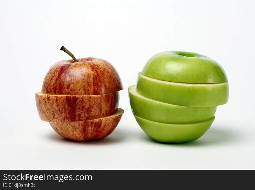 Red and green sliced apples isolated on white