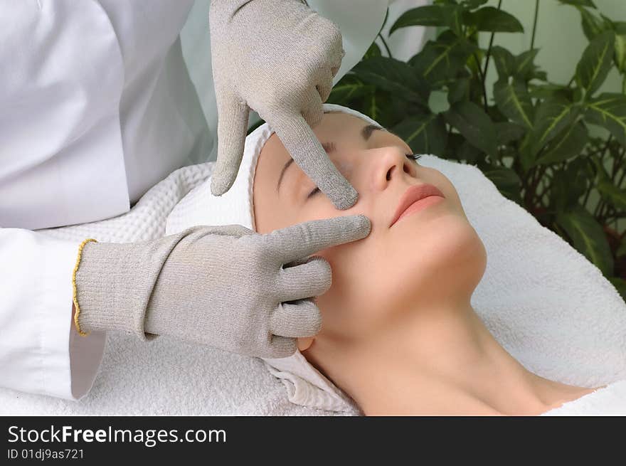 Woman getting special facial massage in the beauty salon. Woman getting special facial massage in the beauty salon