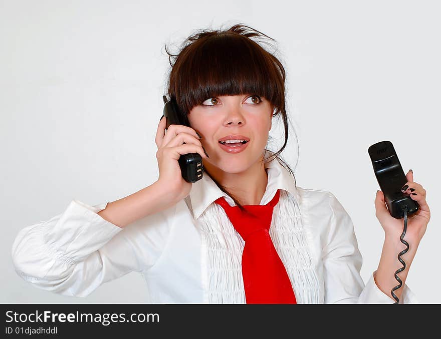 The fine girl at office with two phones