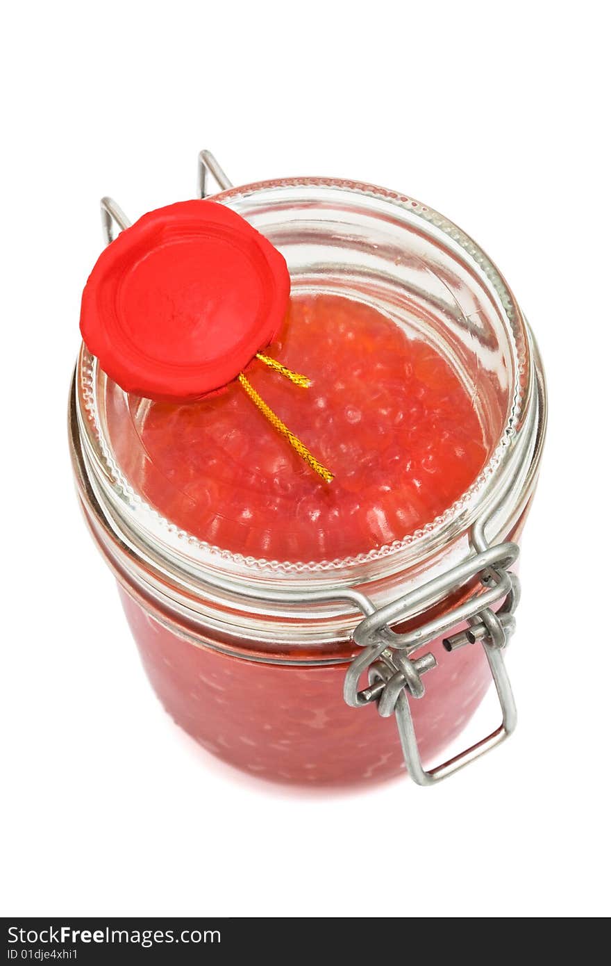 Red caviar in glass can on a white background