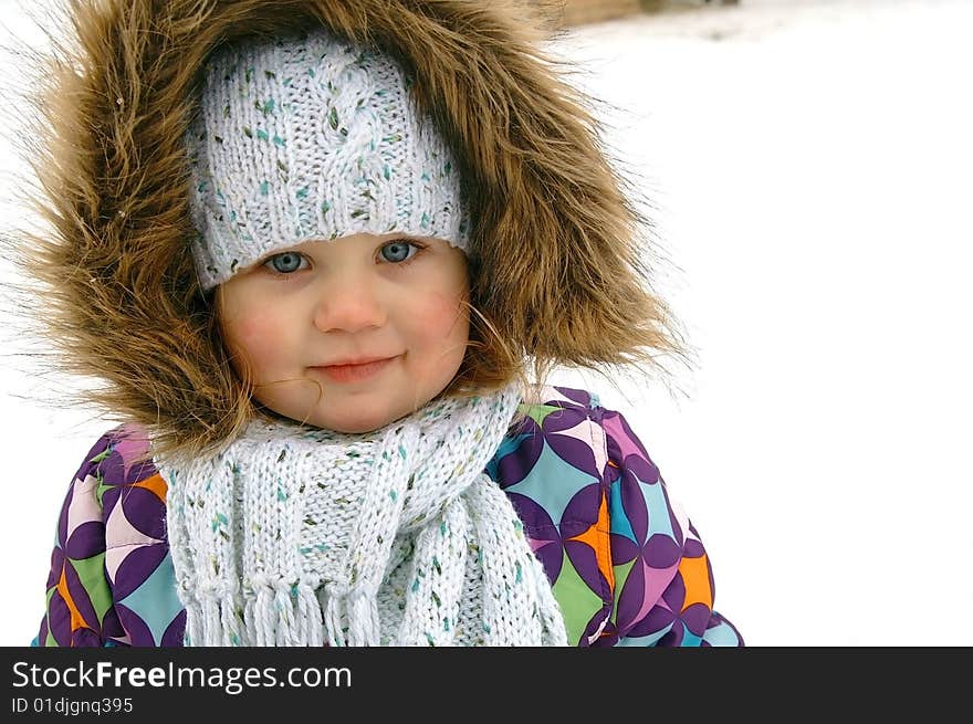 Winter portrait of smiling small girl, background white