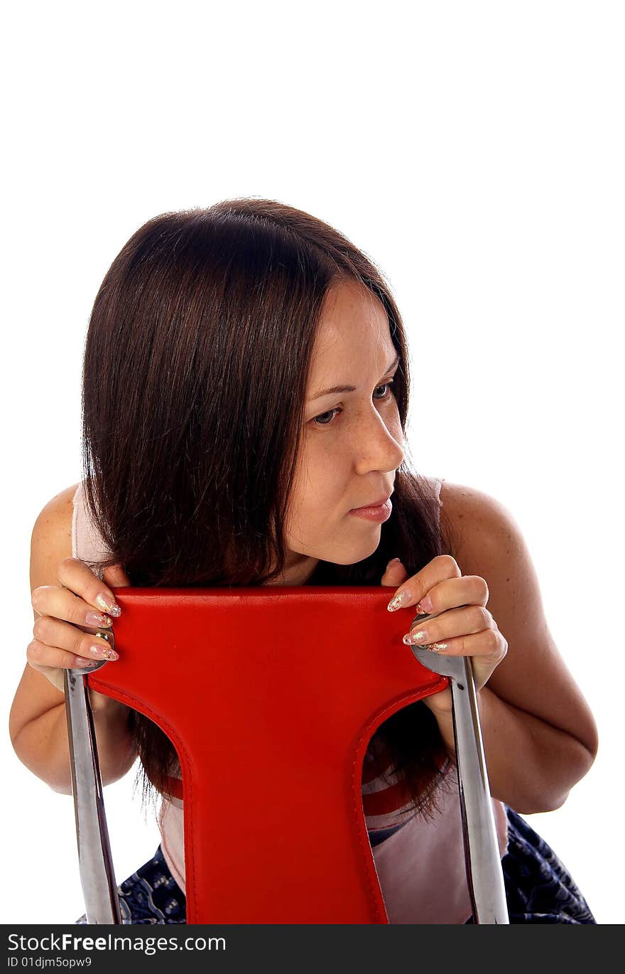 Dark haired young woman is sitting on the read modern chair. Dark haired young woman is sitting on the read modern chair