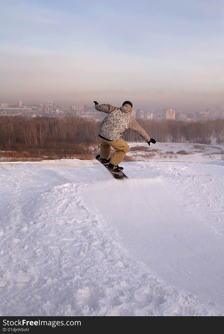 Snowboarder Flying Over The Snowy City