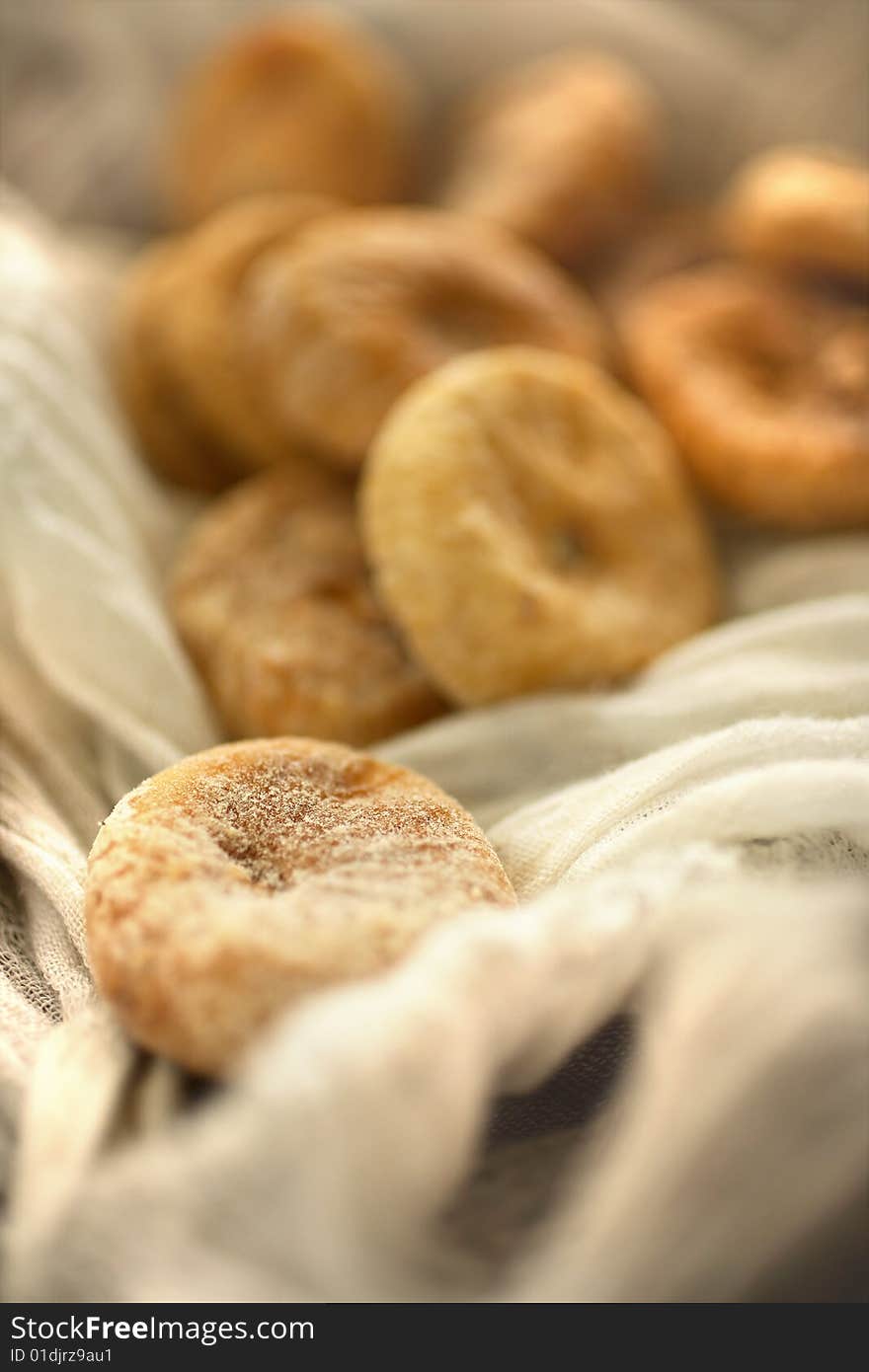 Dry figs in linen tablecloth on table