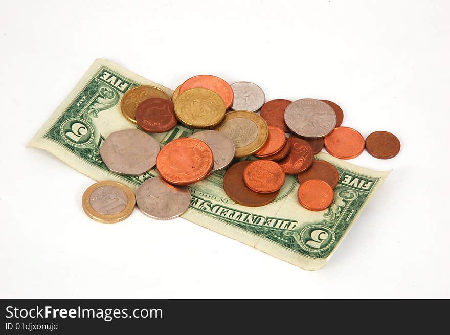 Five dollar paper money with worldwide coins isolated on the white background. Five dollar paper money with worldwide coins isolated on the white background.