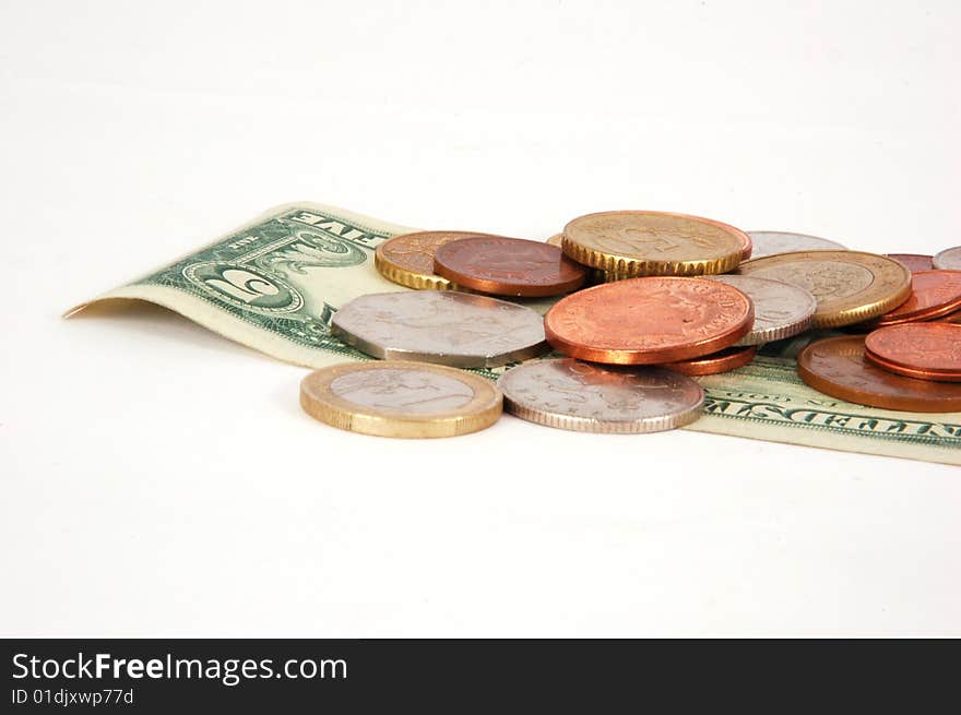 Five dollar paper money with worldwide coins isolated on the white background. Five dollar paper money with worldwide coins isolated on the white background.