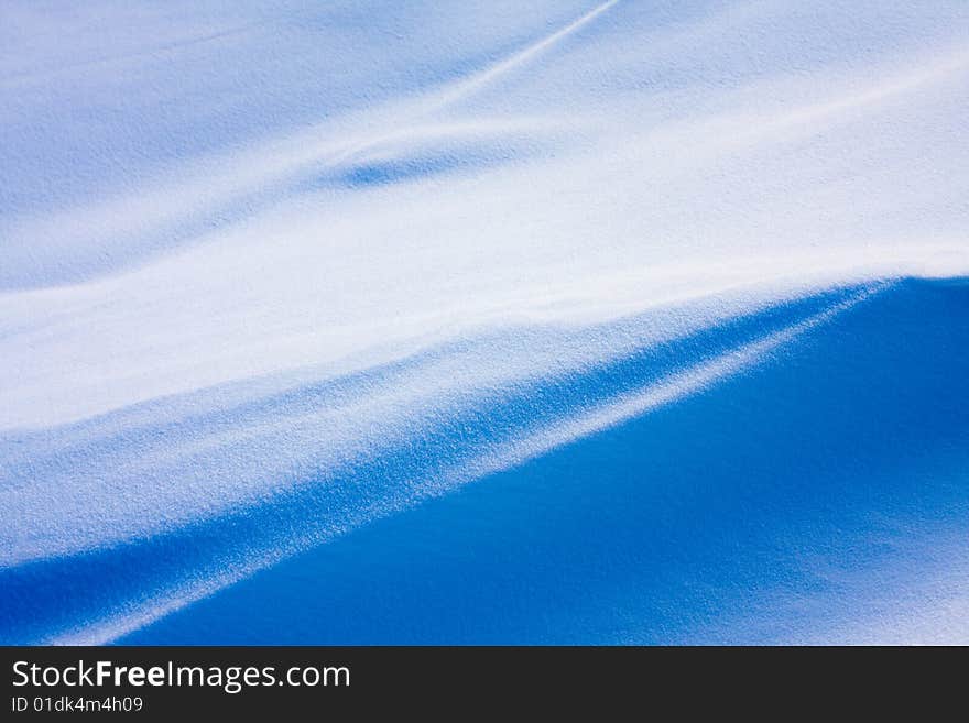 Shadow and light on the snowfield in a cold day