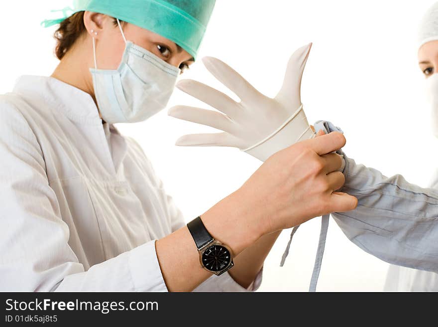 Two young doctors put on a glove Isolated on white background