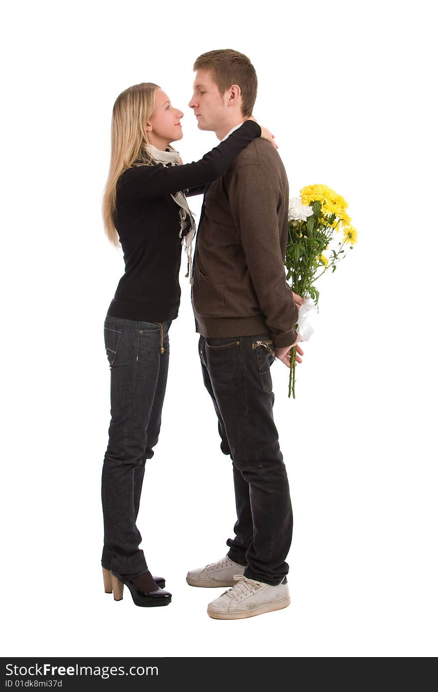 Appointment. The enamoured guy and the girl with a bouquet of yellow flowers.