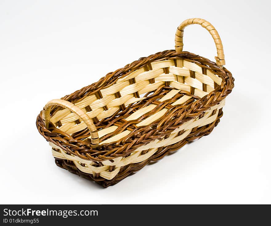 Bast basket from wooden strips of yellow and brown