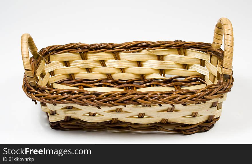 Bast basket from wooden strips of yellow and brown colour