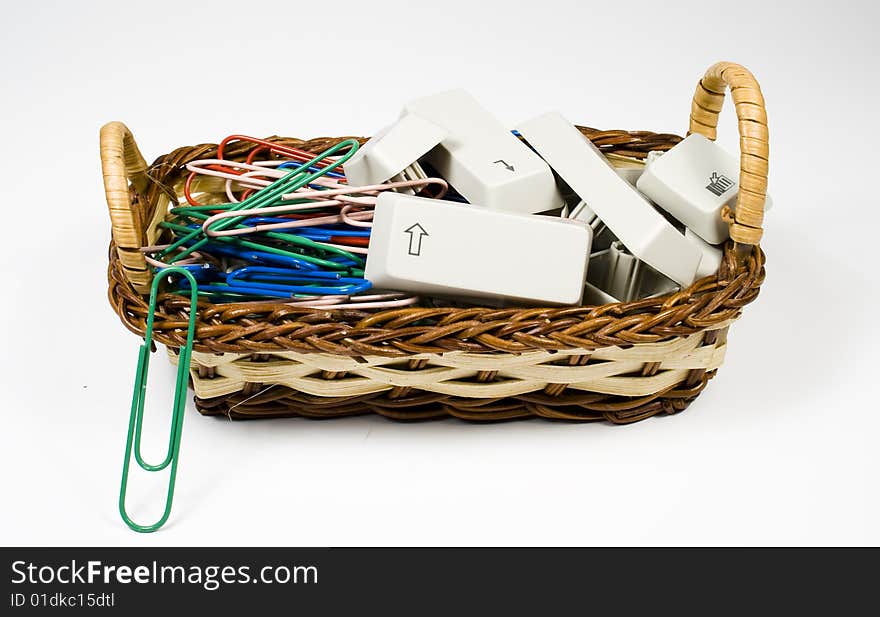 Bast basket with destroyed keyboard buttons and colored paper clips