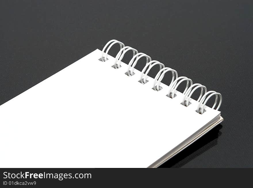 White notebook black background isolated.