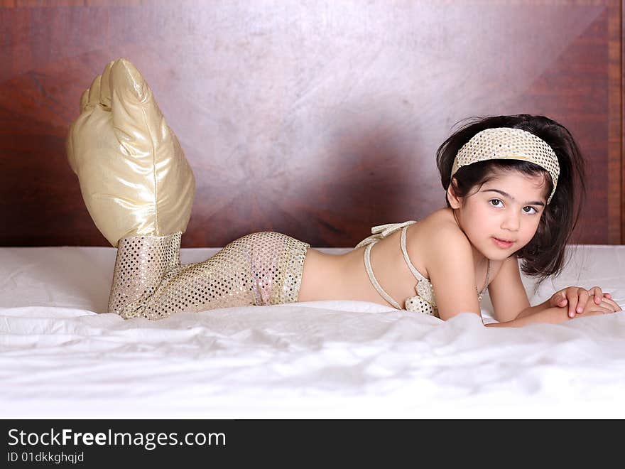 Little mermaid laying on the bed.