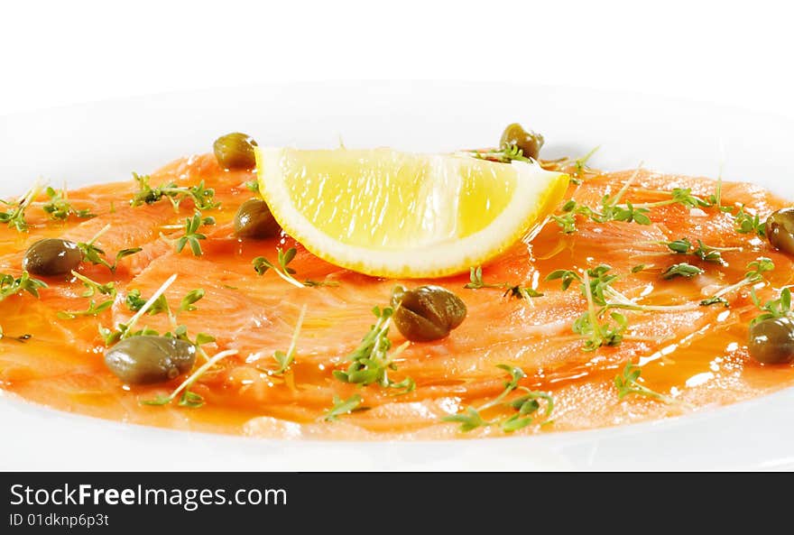 Salmon Carpaccio with Greens and Lemon. Isolated on White Background