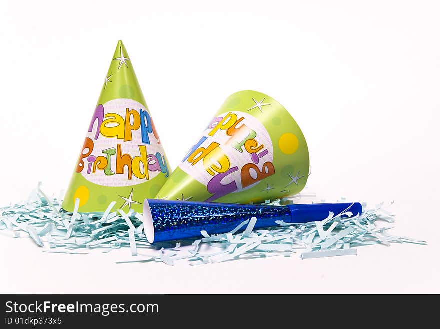 Party hats and paper horns on a white background