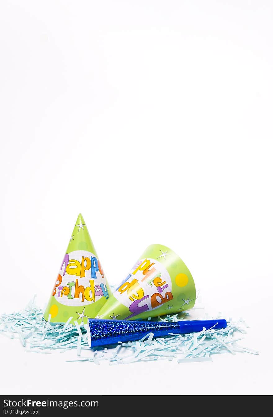 Party hats and paper horns on a white background