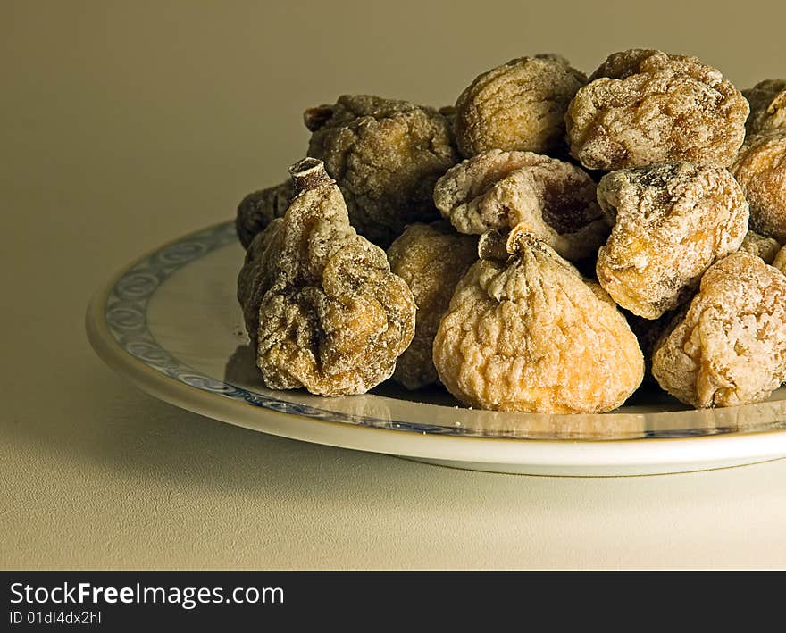 Dried figs on a plate in a retro image style.