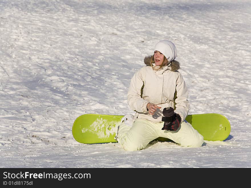 Woman with snowboard sitting