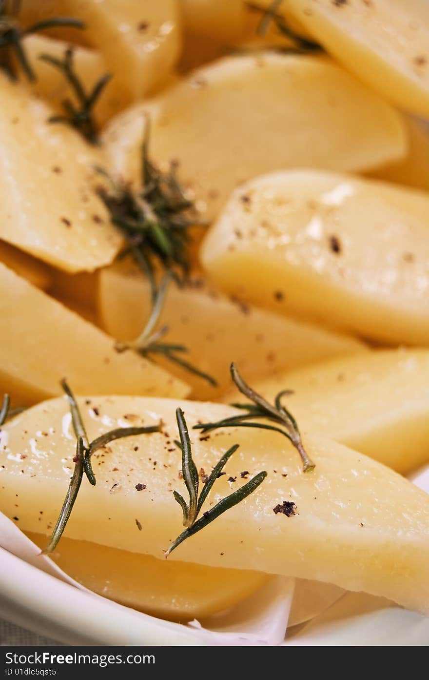 Raw yellow potatoes with oil and rosemery