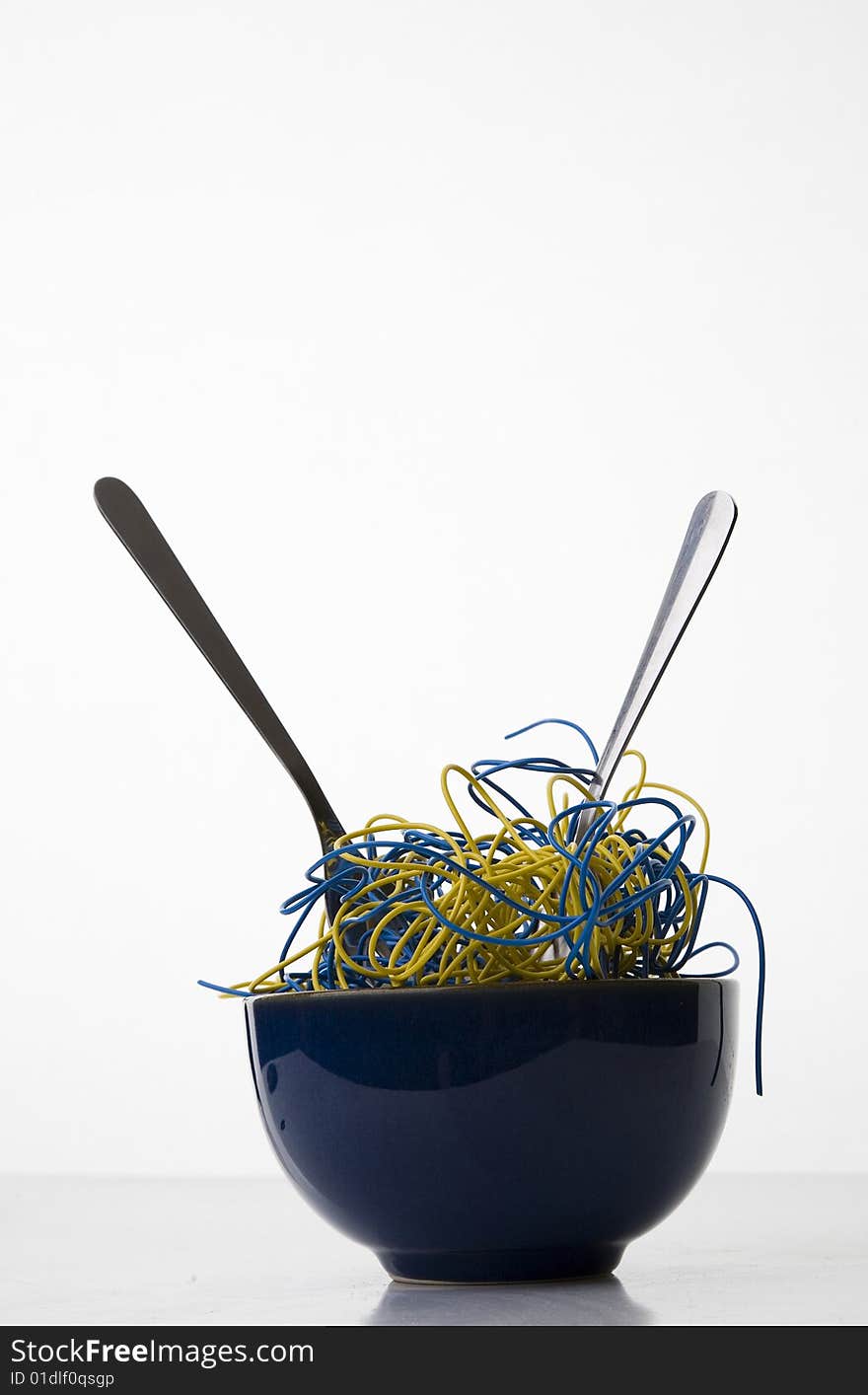 Bowl of Noodles Made of Blue and Yellow Computer Wires - Concept of Synthetic Food isolated on White. Bowl of Noodles Made of Blue and Yellow Computer Wires - Concept of Synthetic Food isolated on White