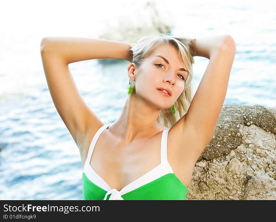 Beautiful young woman relaxing near the ocean