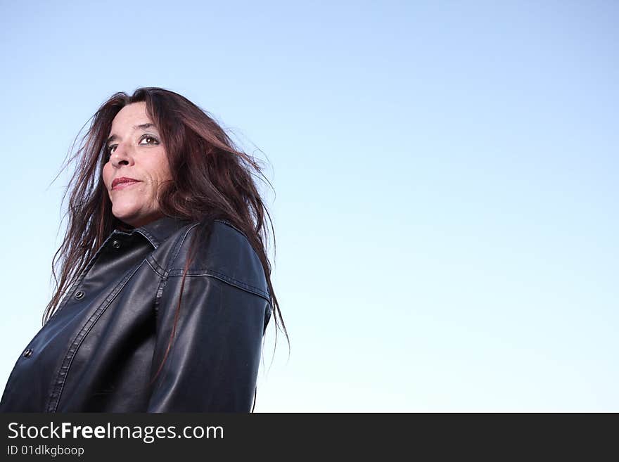 Middle aged female on a clear blue sky. Middle aged female on a clear blue sky