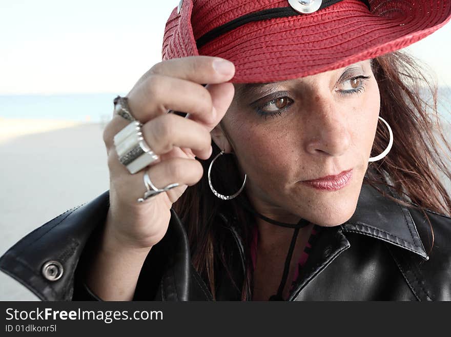 Middle aged female wearing a red cowboy hat. Middle aged female wearing a red cowboy hat