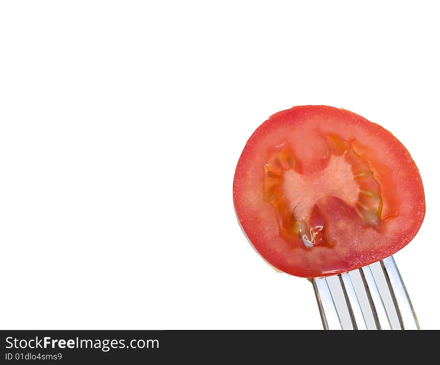 Slice of the red tomato on  a fork