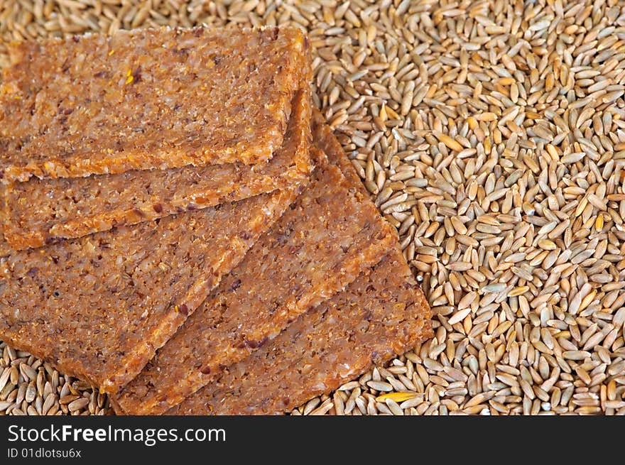 Close up of wholegrain bread and rye grains.