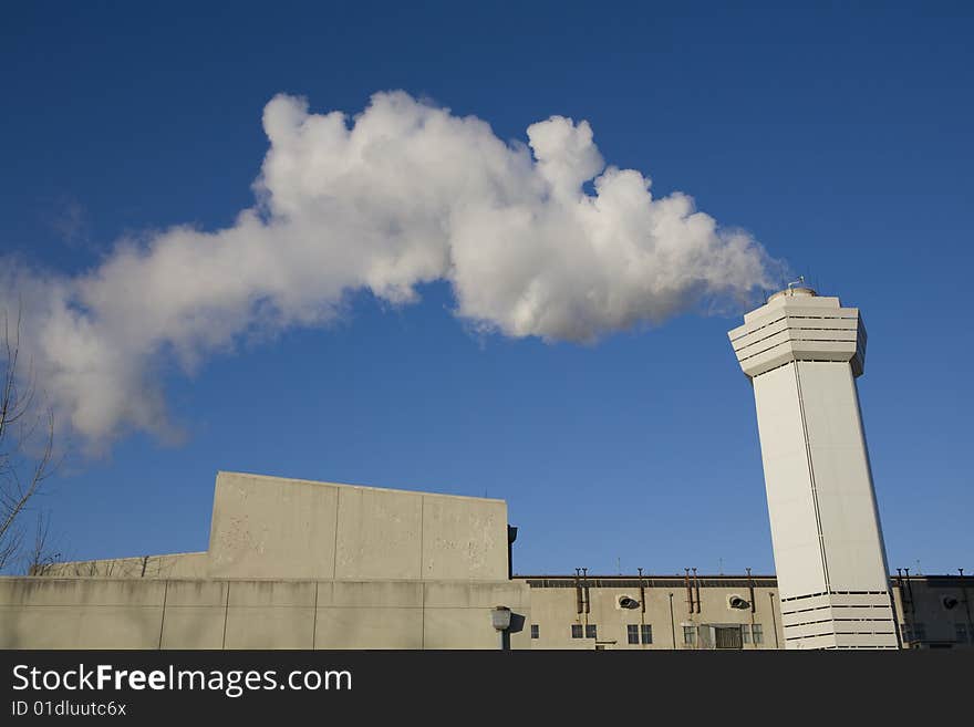 Large cloud of steam coming from a stack. Large cloud of steam coming from a stack