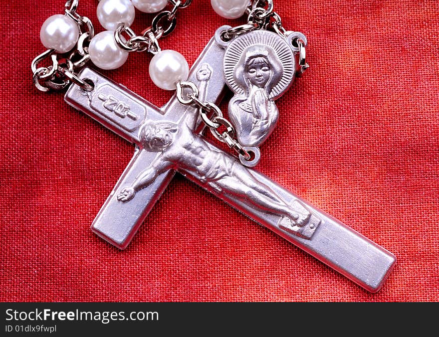 Rosary in macro over red cloth background. Rosary in macro over red cloth background