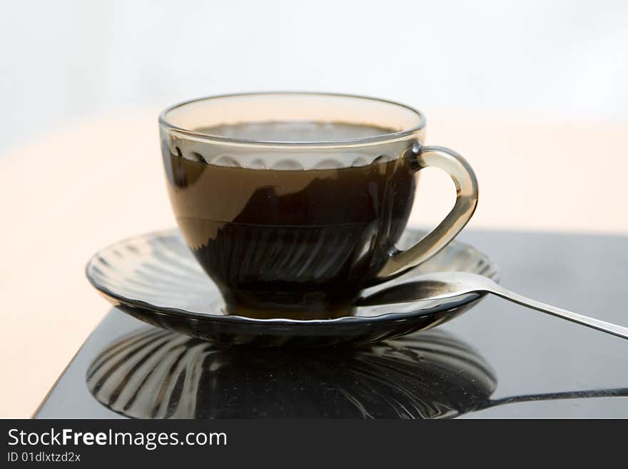 Espresso coffee cup with steel spoon on the laptop