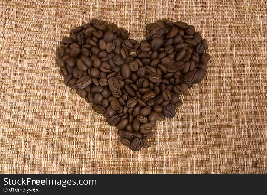 Coffee beans close-up isolated on a beige sacking