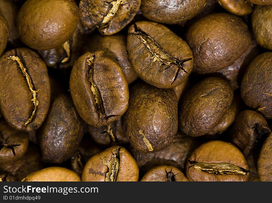 Background from the spilled grains of Brazilian coffee