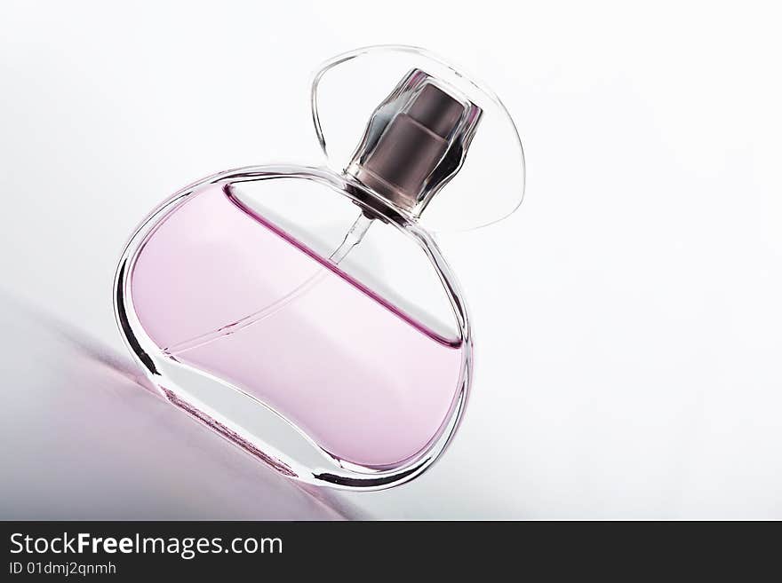 Transparent bottle of pink perfume