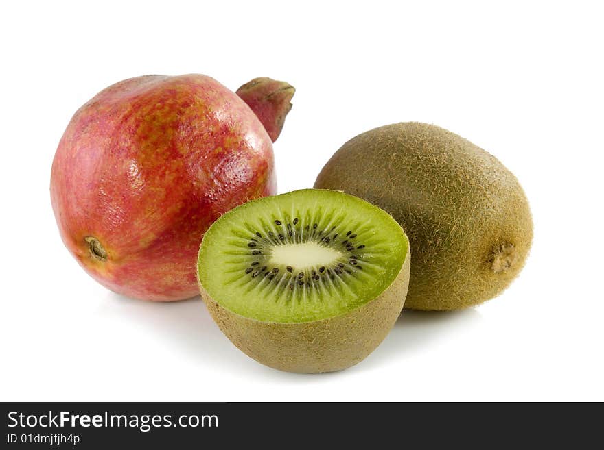 Pomegranate and kiwi fruit on white background