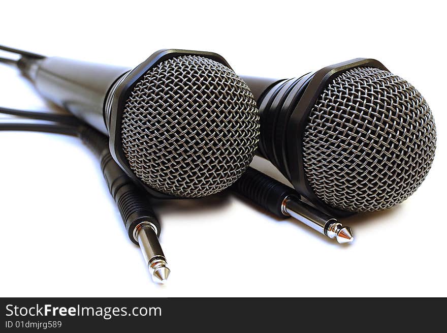 Two black wired karaoke microphones.