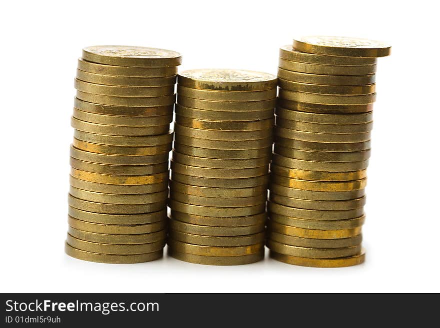 Three stacks of golden coins isolated on white