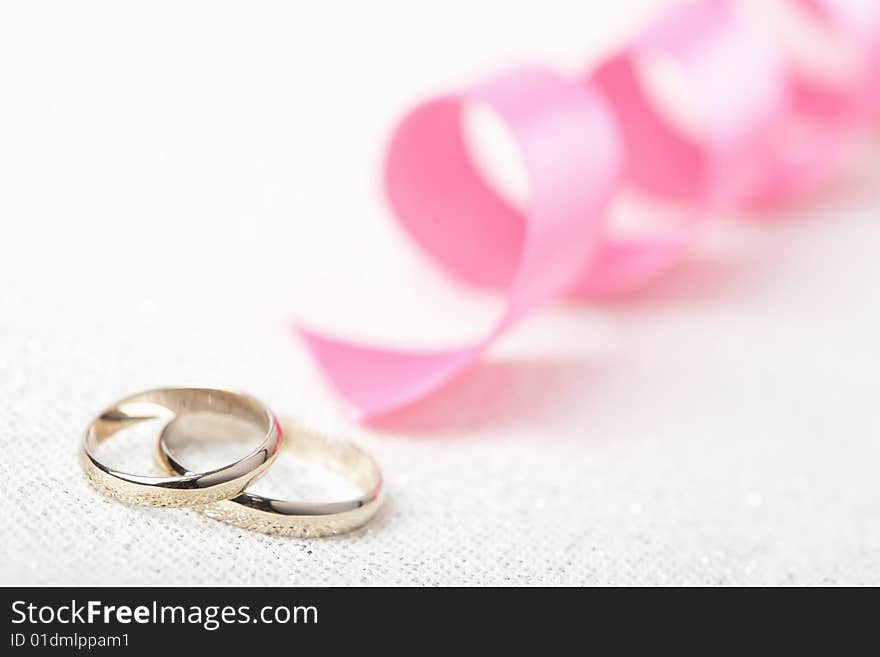 Golden wedding rings and ribbon