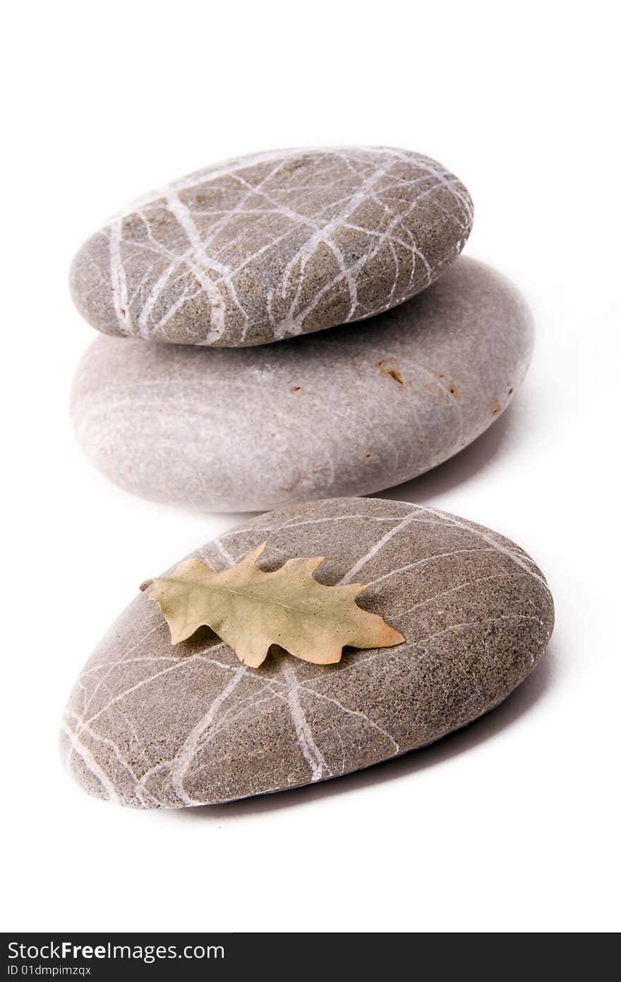 Stones with dry leaf on a white backgroun