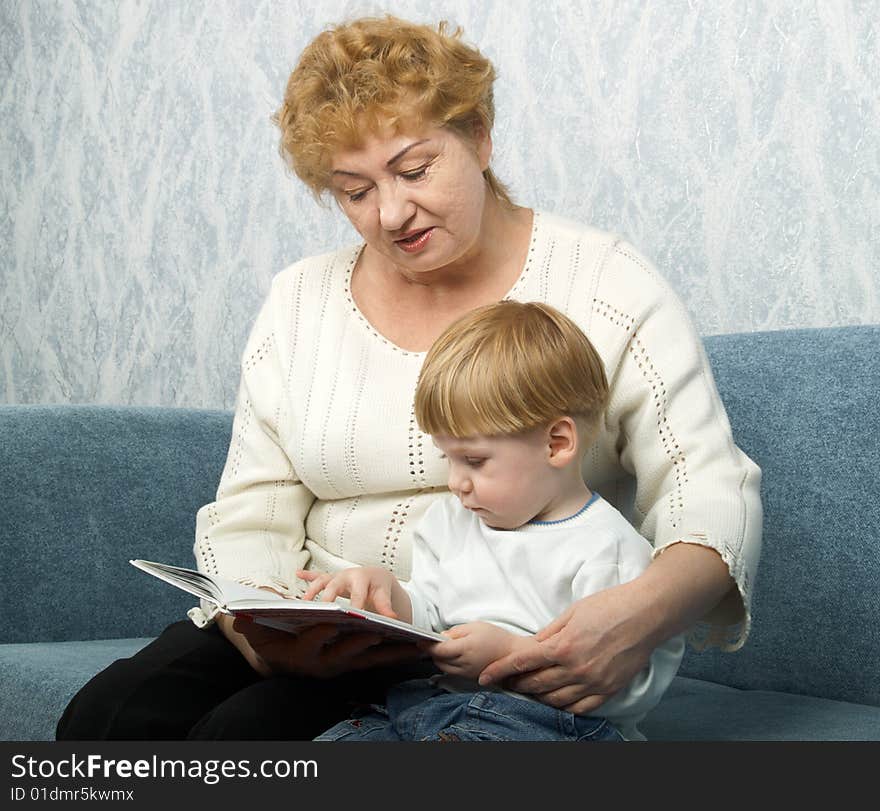 Portrait of the grandmother with the grandson in house conditions