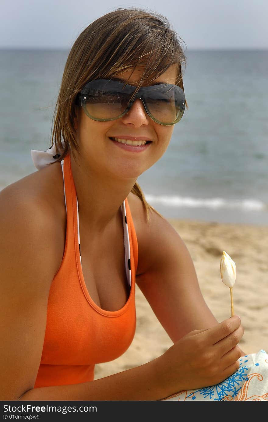 Girl eating ice-cream in the beach. Girl eating ice-cream in the beach