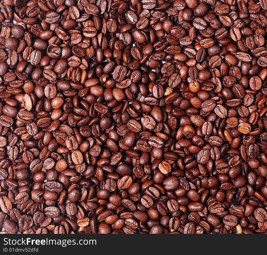 Heap of burnt brown arabica coffee beans