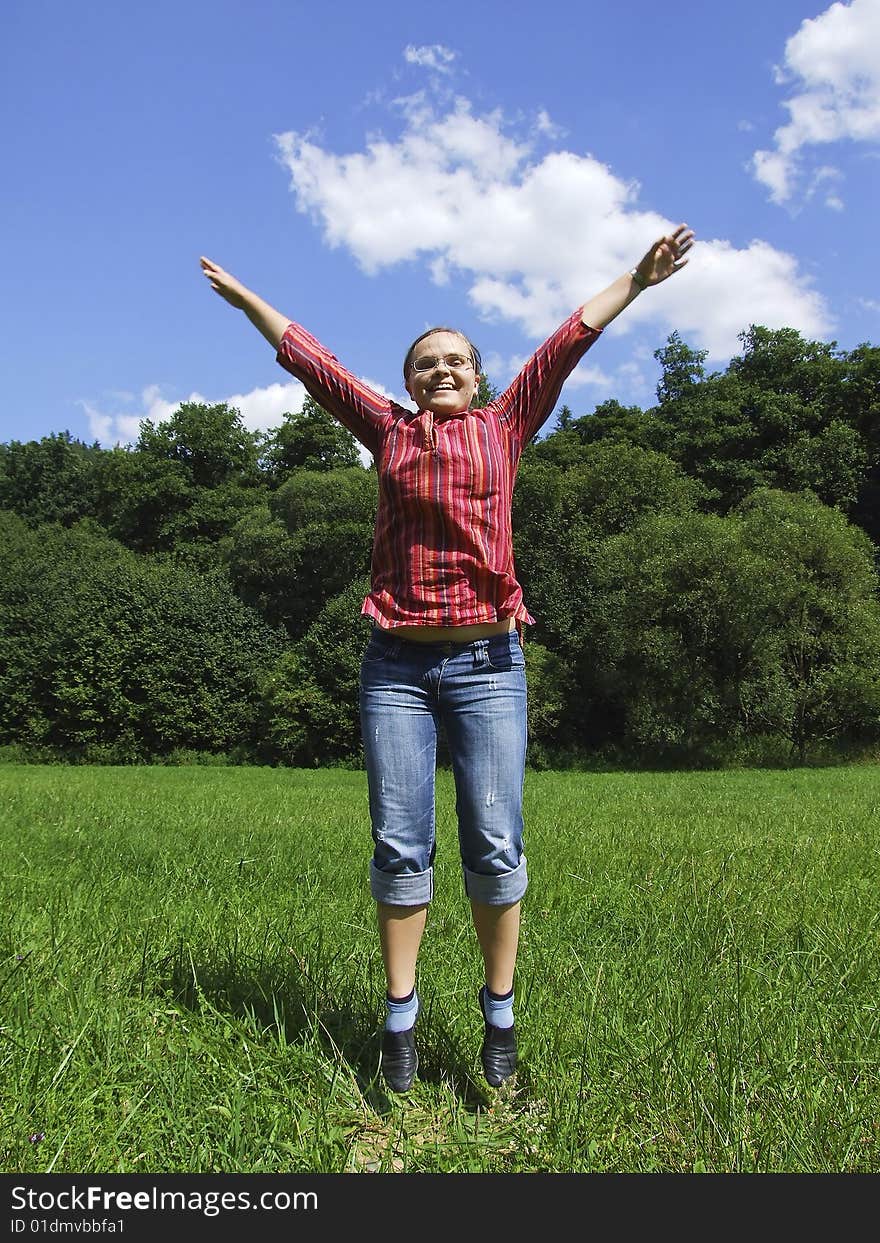 Happy woman jumps on a meadow. Happy woman jumps on a meadow