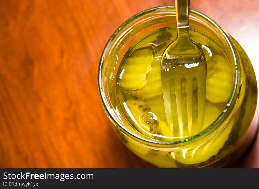 Cucumber being picked from a glass jar. Cucumber being picked from a glass jar